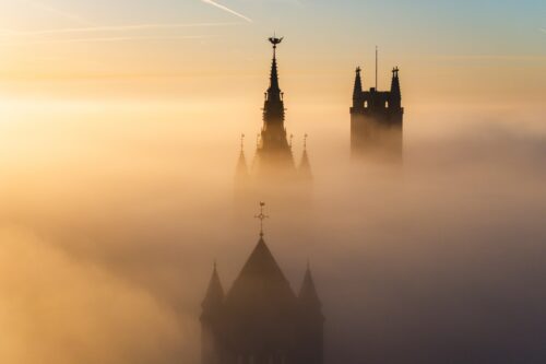 Sunrise fog between the towers of Ghent